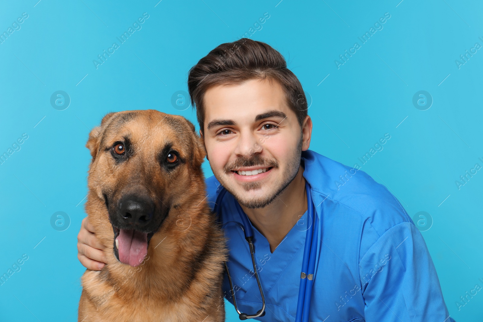 Photo of Veterinarian doc with dog on color background