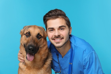 Veterinarian doc with dog on color background