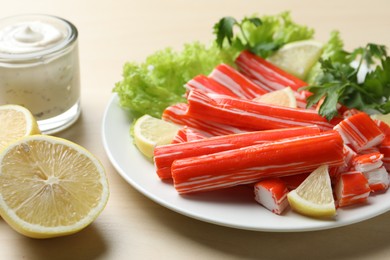 Delicious crab sticks served on wooden table, closeup