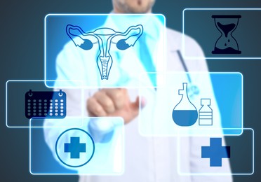 Image of Menopause concept. Doctor touching uterus icon on digital screen against blue background, closeup