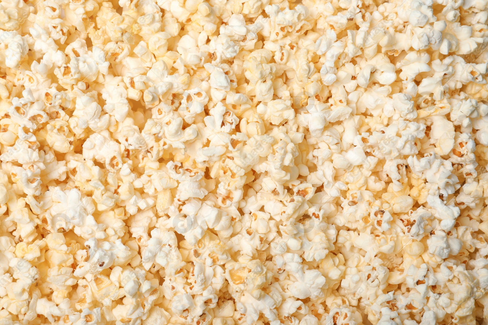 Photo of Fresh tasty popcorn as background, top view