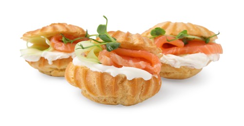 Photo of Delicious profiteroles with cream cheese and salmon isolated on white