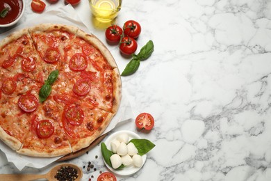 Photo of Delicious pizza Margherita and ingredients on white marble table, flat lay. Space for text