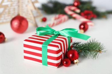 Christmas gift box and decor on white table, closeup