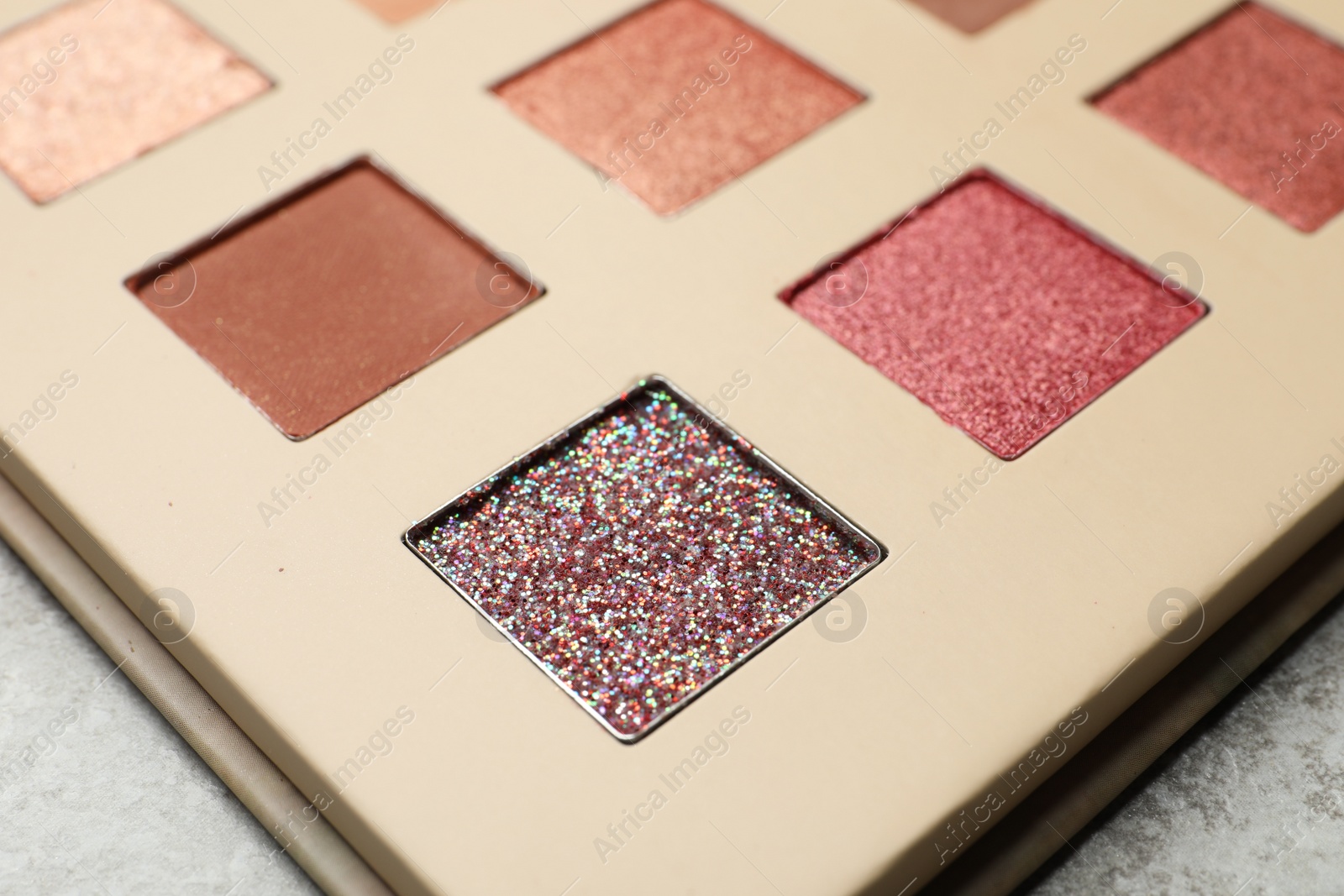 Photo of Beautiful eye shadow palette on grey table, closeup