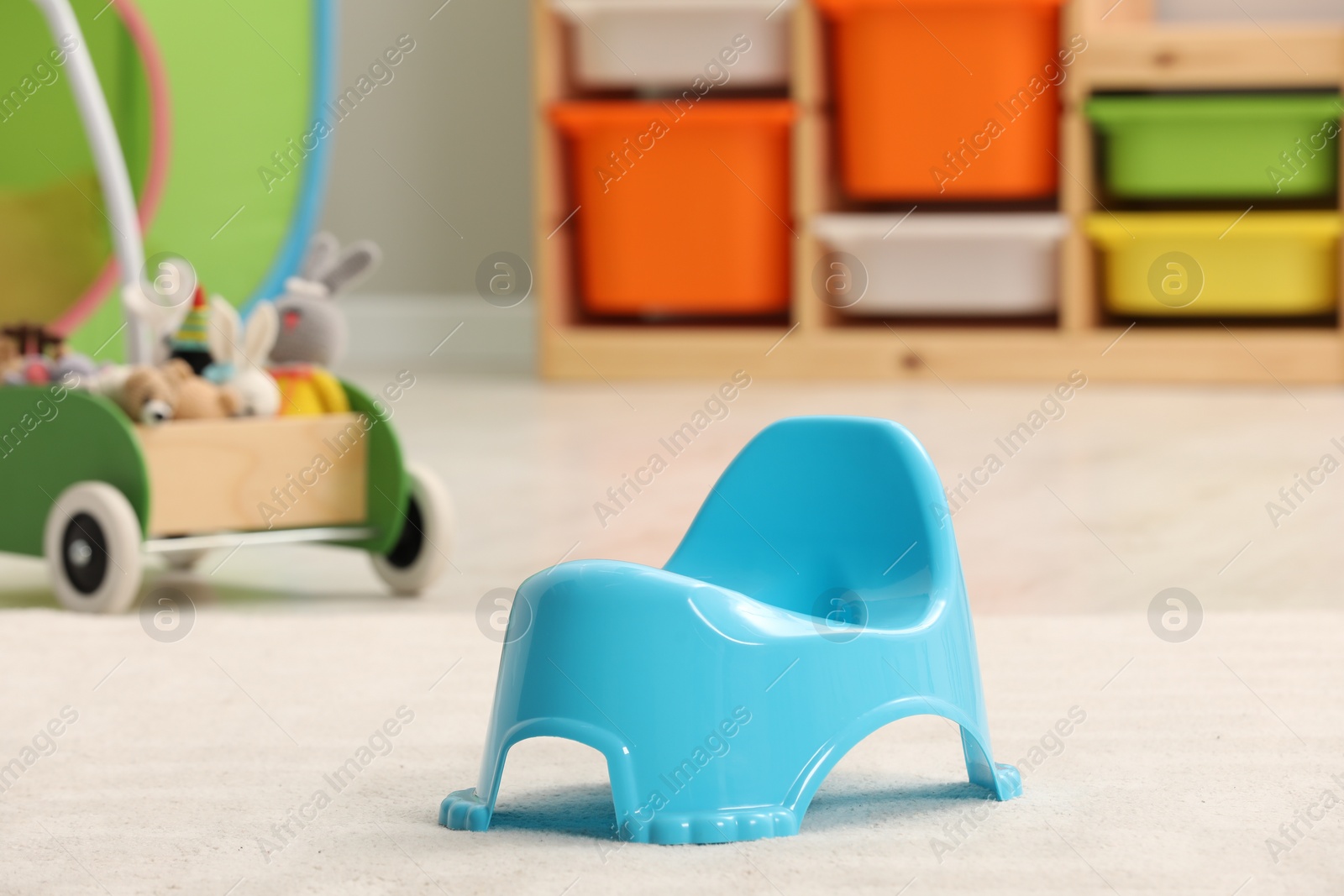 Photo of Light blue baby potty in room. Toilet training