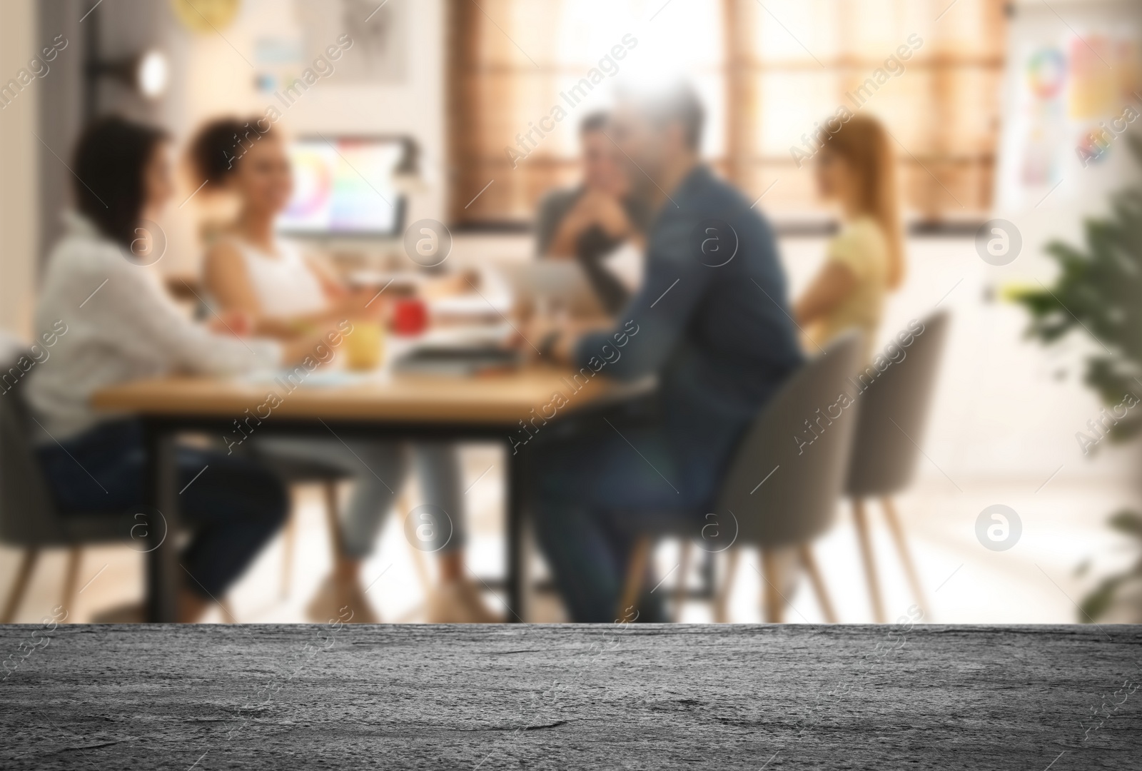 Image of Empty stone surface and blurred view of professional interior designers working in office, closeup. Space for text 