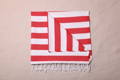 Photo of Striped beach towel on sand, top view