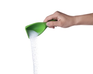 Woman pouring laundry detergent from measuring container against white background, closeup