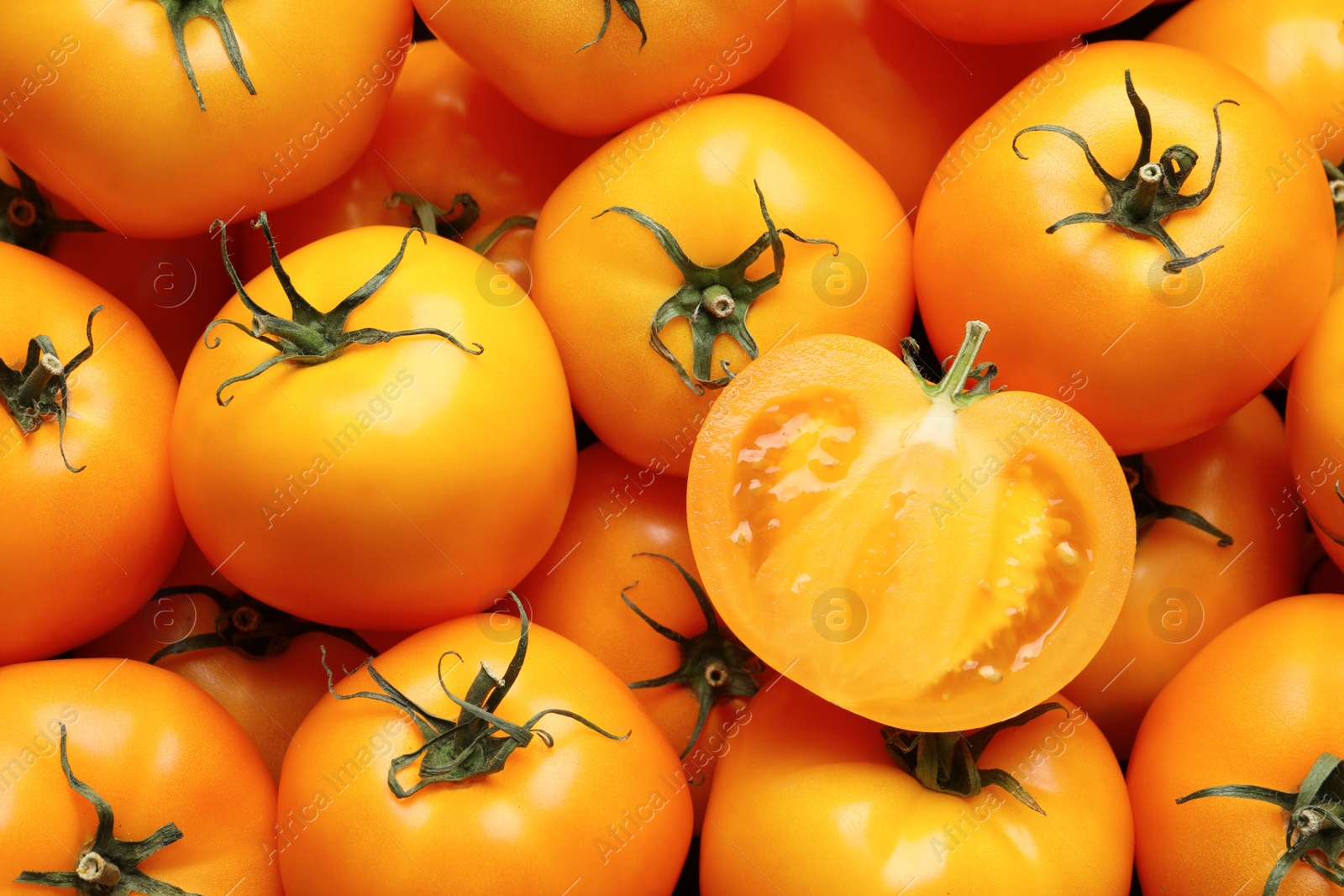 Photo of Fresh ripe yellow tomatoes as background, closeup view