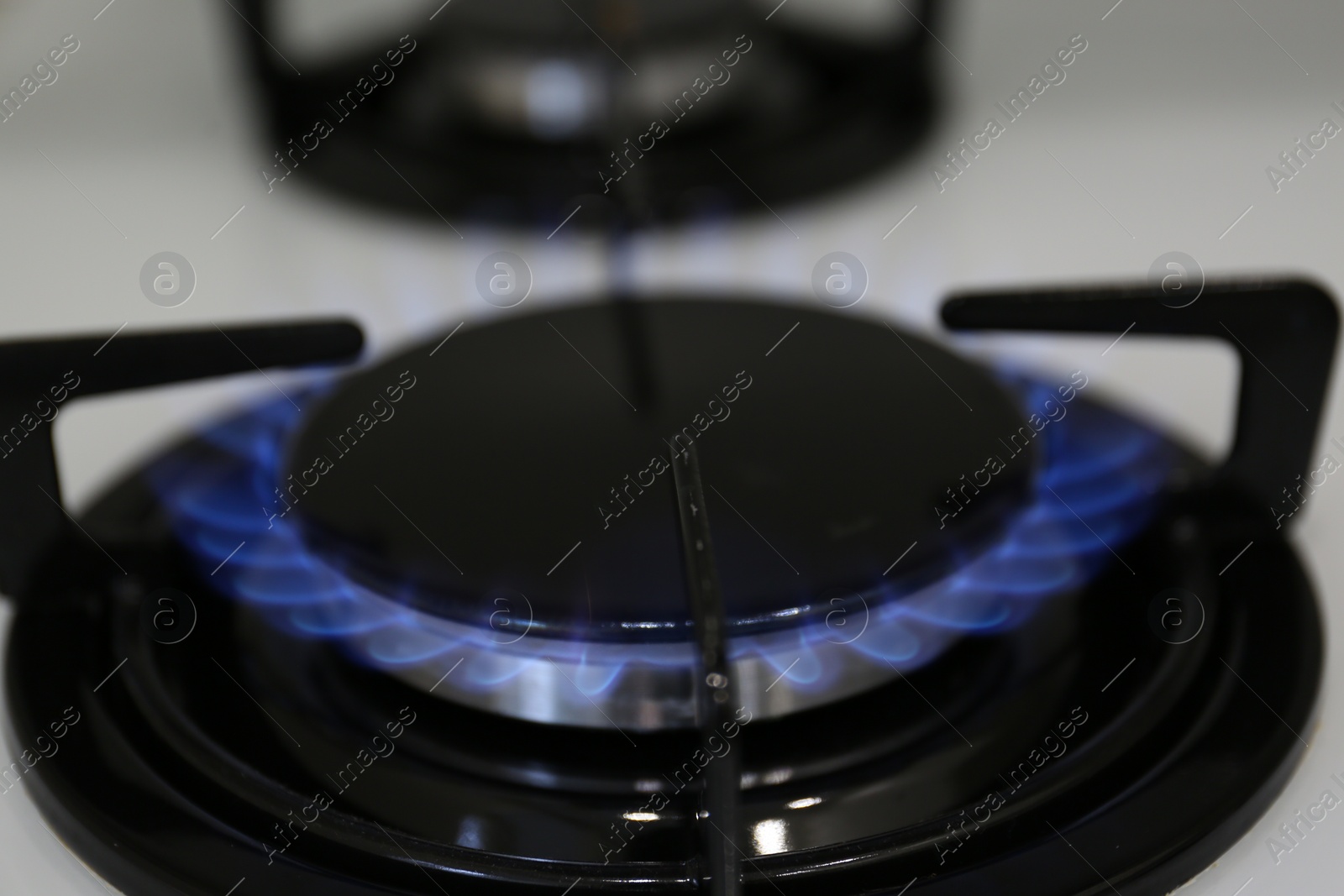 Photo of Modern kitchen stove with burning gas, closeup