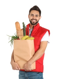 Man holding paper bag with fresh products on white background. Food delivery service