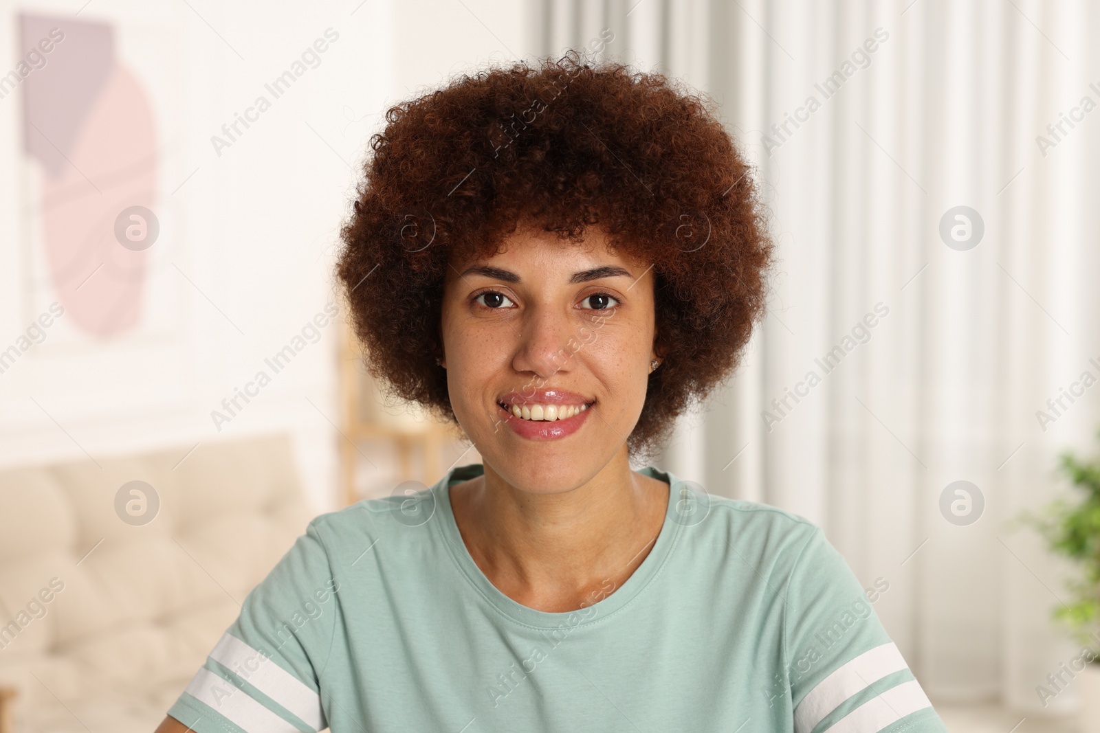 Photo of Portrait of happy young woman in room