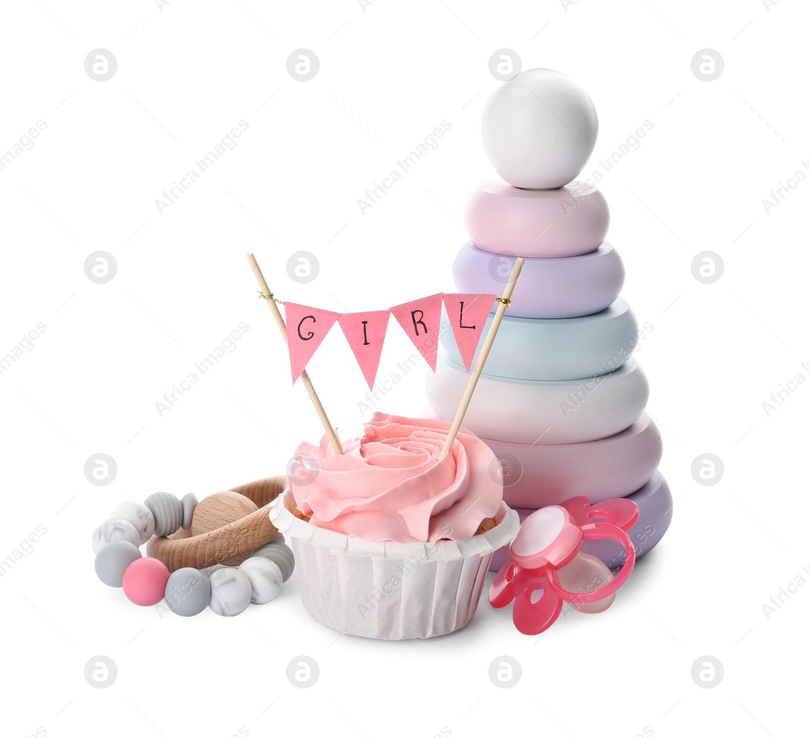 Photo of Baby shower cupcake with Girl topper near pacifier and toys on white background