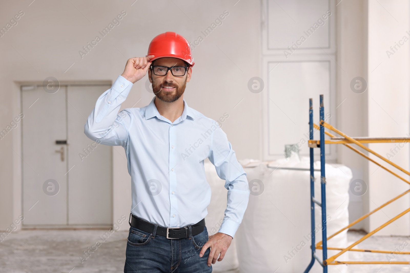 Photo of Portrait of professional engineer in hard hat indoors