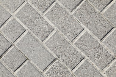 Photo of Pavement with grey tiles as background, top view