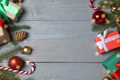 Christmas greeting card with space for text. Flat lay composition of fir tree branches and festive decor on wooden background