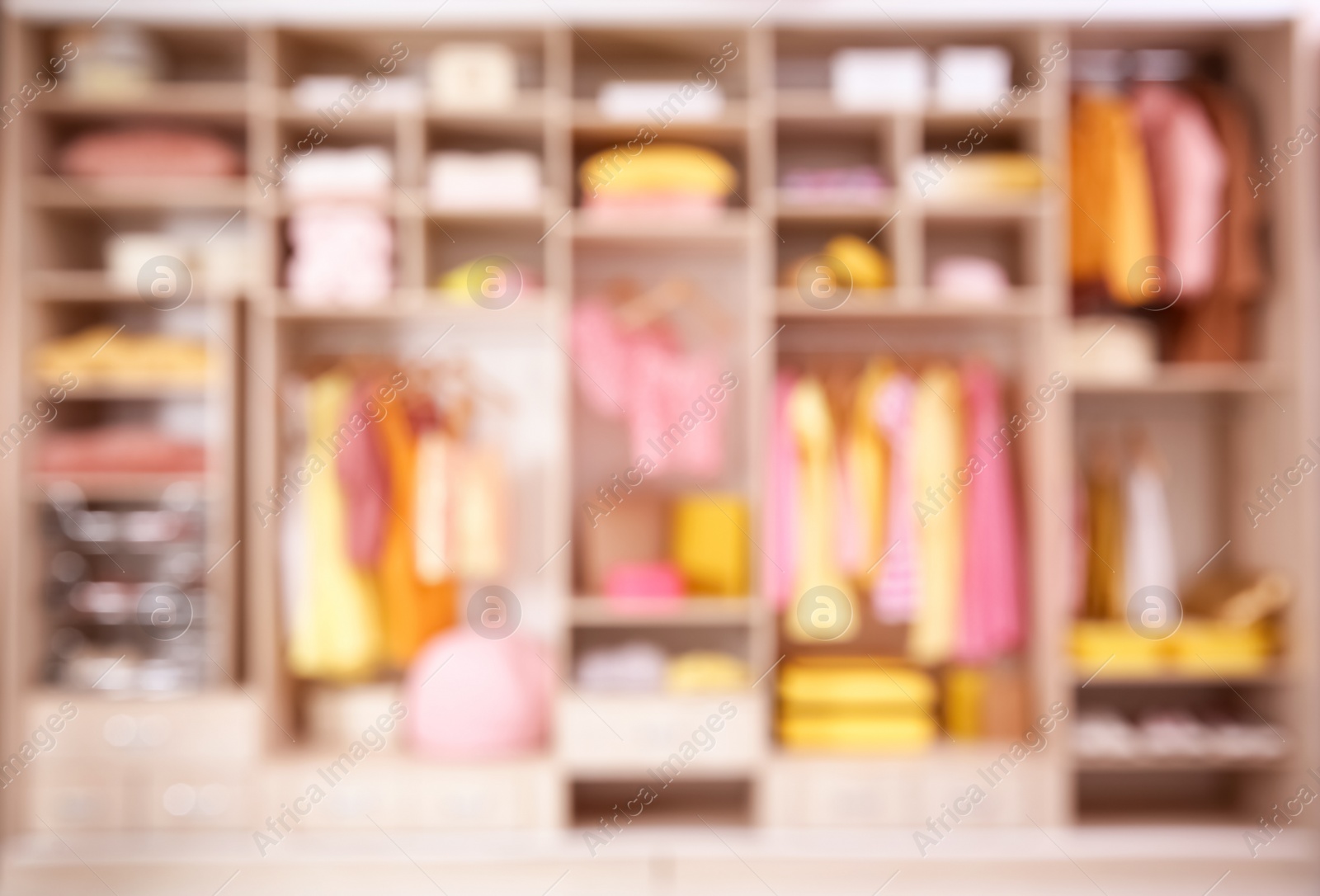 Photo of Blurred view of large wardrobe with stylish clothes