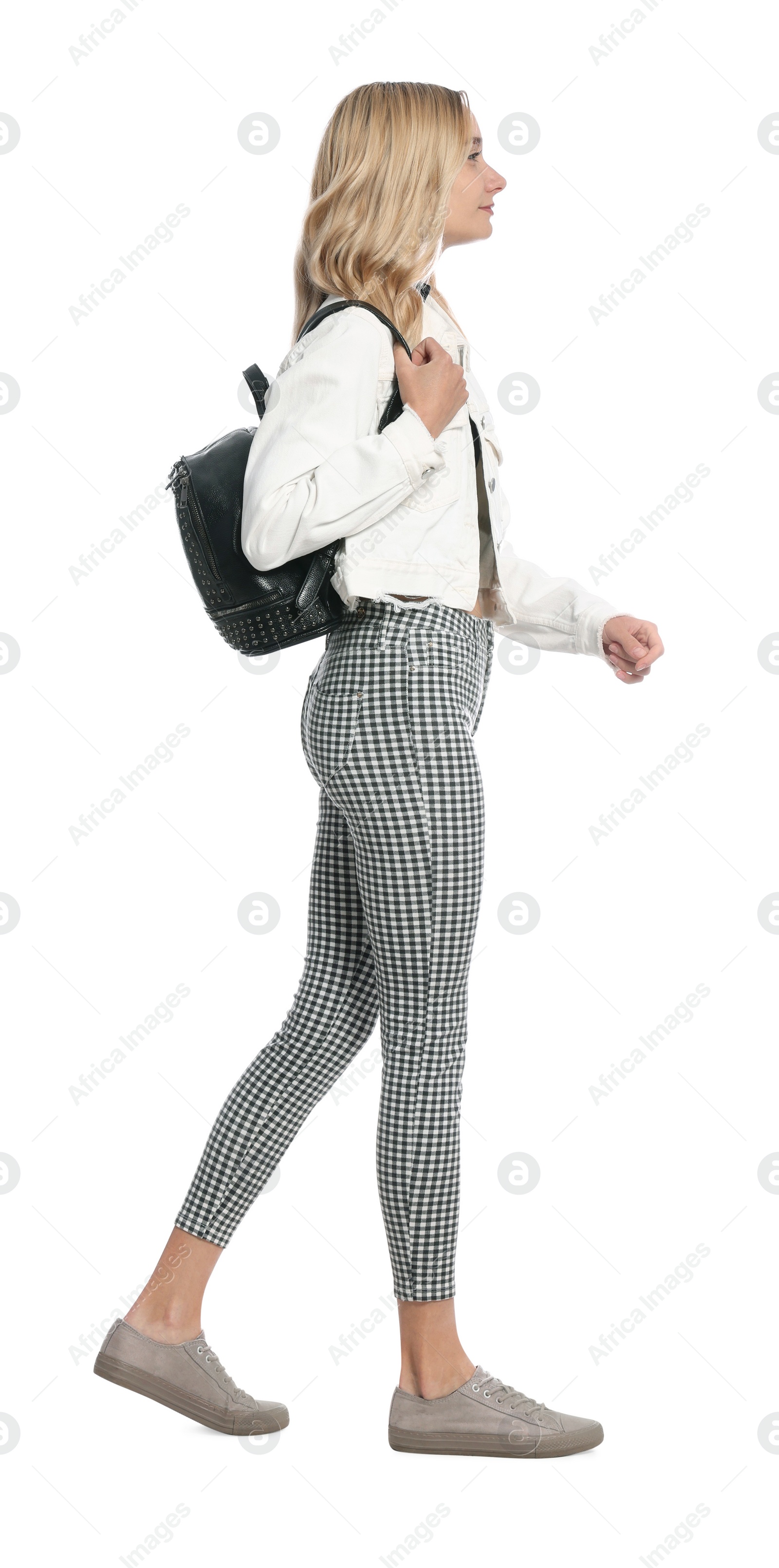 Photo of Young woman with black bag walking on white background