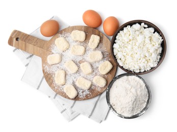 Photo of Making lazy dumplings. Wooden board with cut dough and ingredients isolated on white, top view