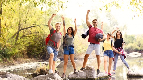 Photo of Group of friends hiking outdoors. Camping vacation