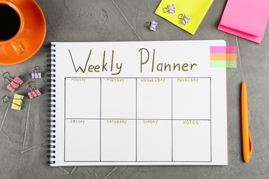 Flat lay composition of notebook with weekly plan on grey table
