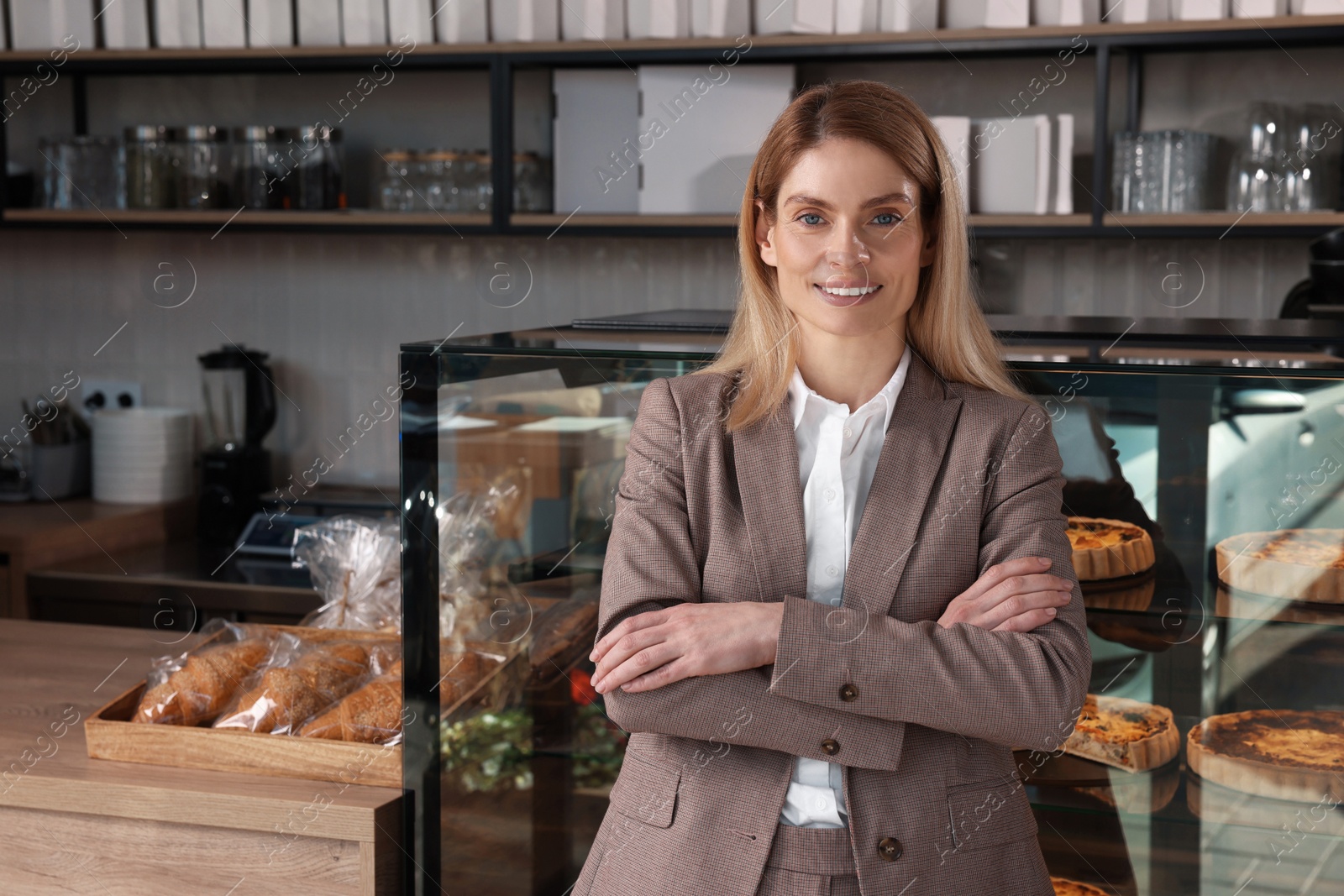 Photo of Happy business owner in bakery shop. Space for text