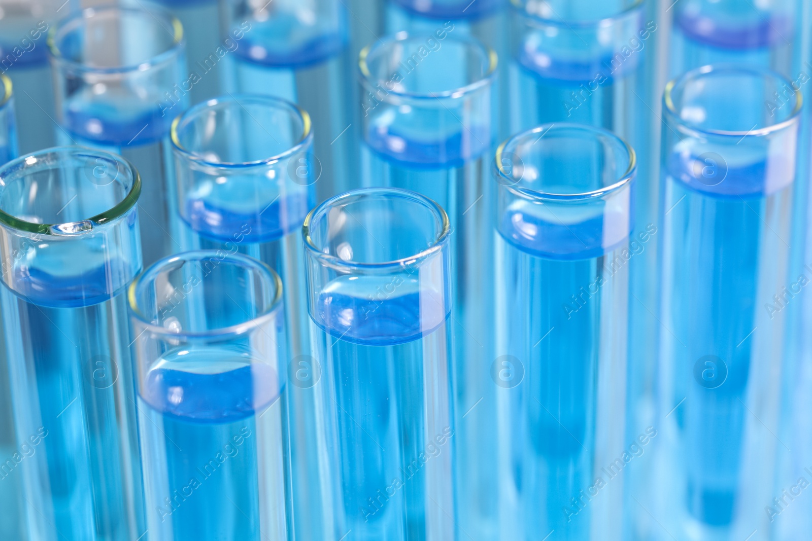 Photo of Test tubes with light blue reagents, closeup. Laboratory analysis