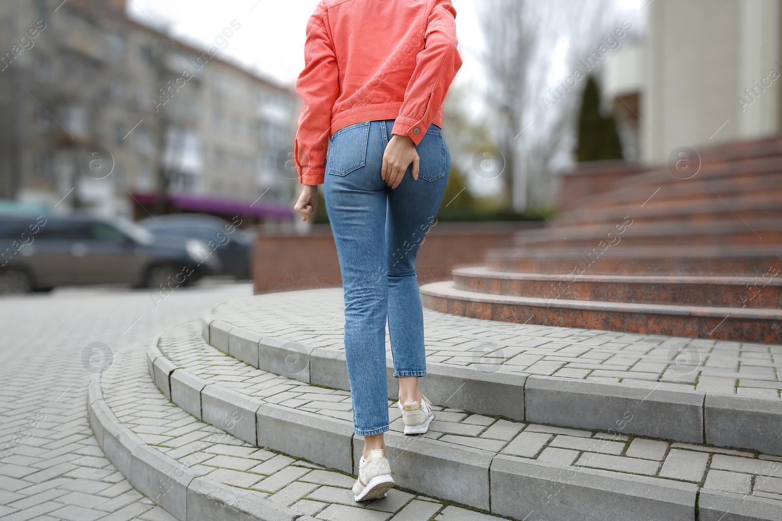 Photo of Woman suffering from hemorrhoid pain outdoors, back view