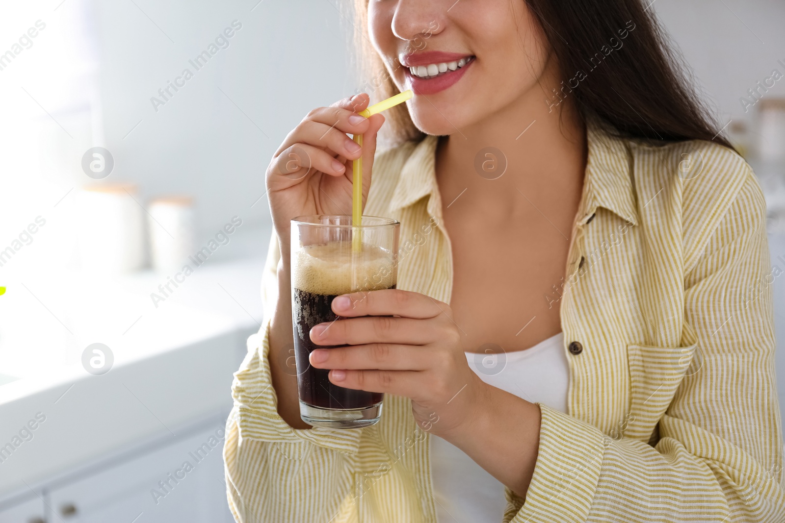 Photo of Young woman with cold kvass indoors, closeup. Traditional Russian summer drink