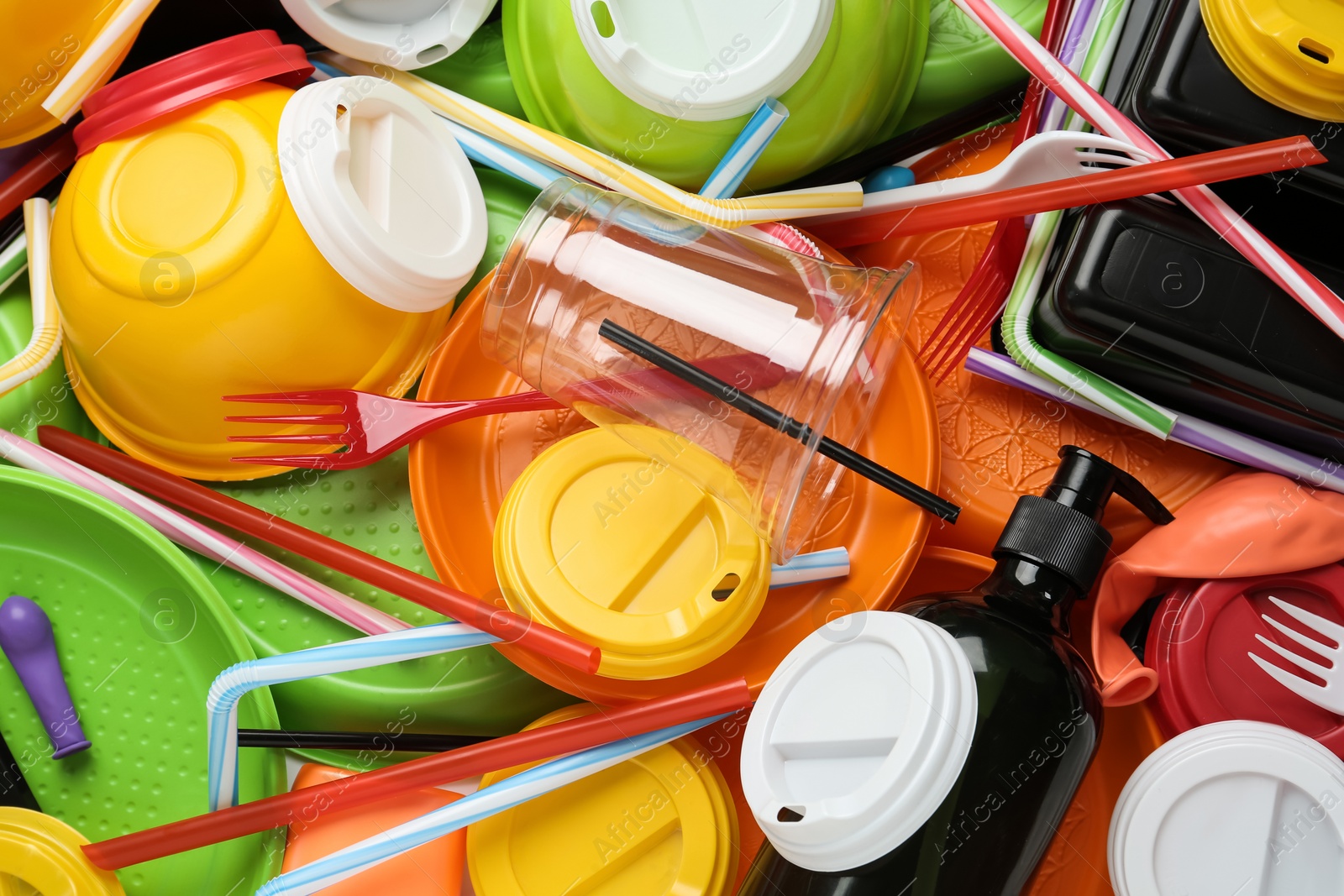 Photo of Different colorful plastic items as background, closeup