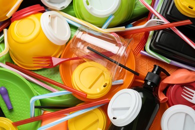 Different colorful plastic items as background, closeup