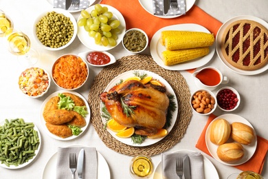 Photo of Delicious festive dinner with roasted turkey on table, flat lay