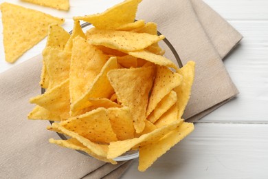 Photo of Tortilla chips (nachos) on white wooden table, flat lay