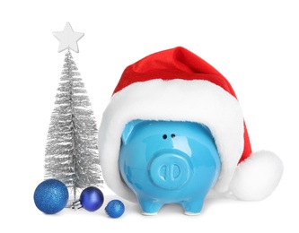 Photo of Composition with piggy bank and Christmas decor on white background