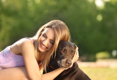 Photo of Cute brown labrador retriever with owner outdoors