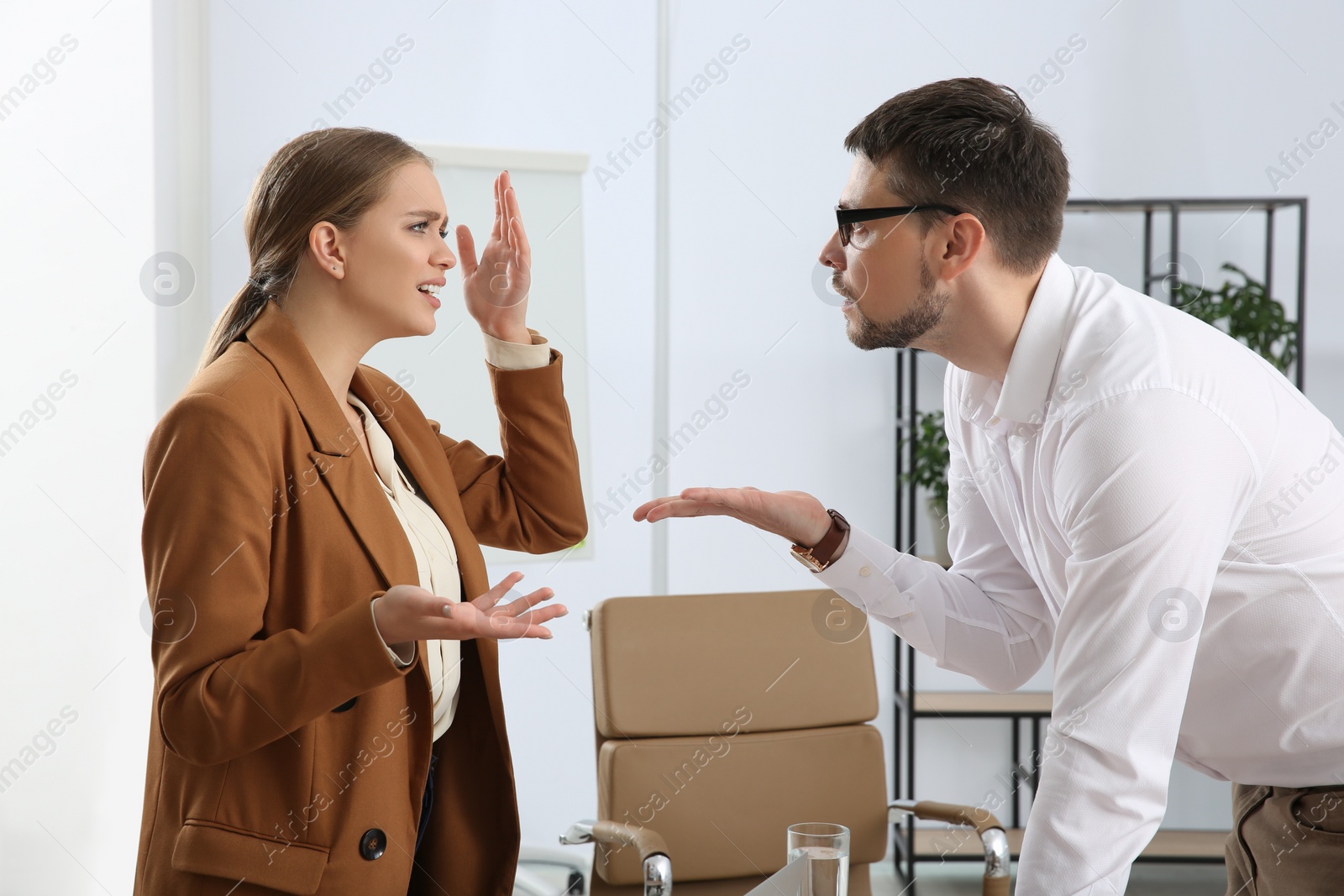 Photo of Emotional colleagues arguing in office. Toxic work environment