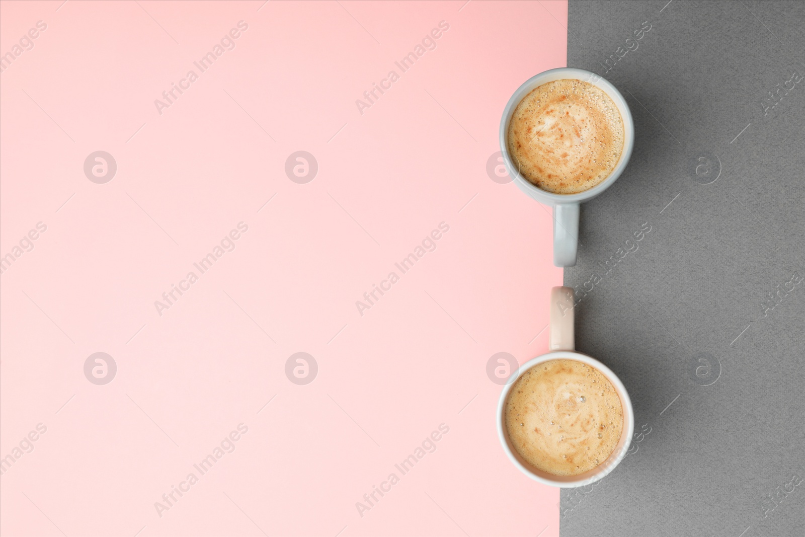 Photo of Cups of coffee on color background, top view. Space for text