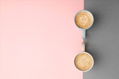 Photo of Cups of coffee on color background, top view. Space for text