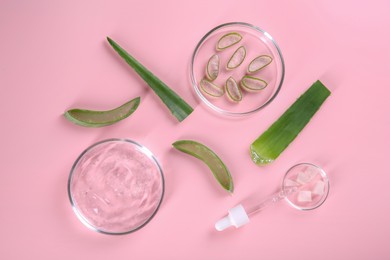 Photo of Flat lay composition with aloe vera leaves and cosmetic gel on pink background