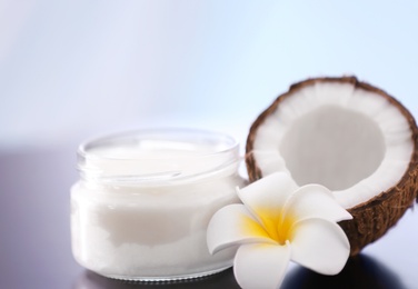 Photo of Composition with coconut butter in glass jar on blurred background