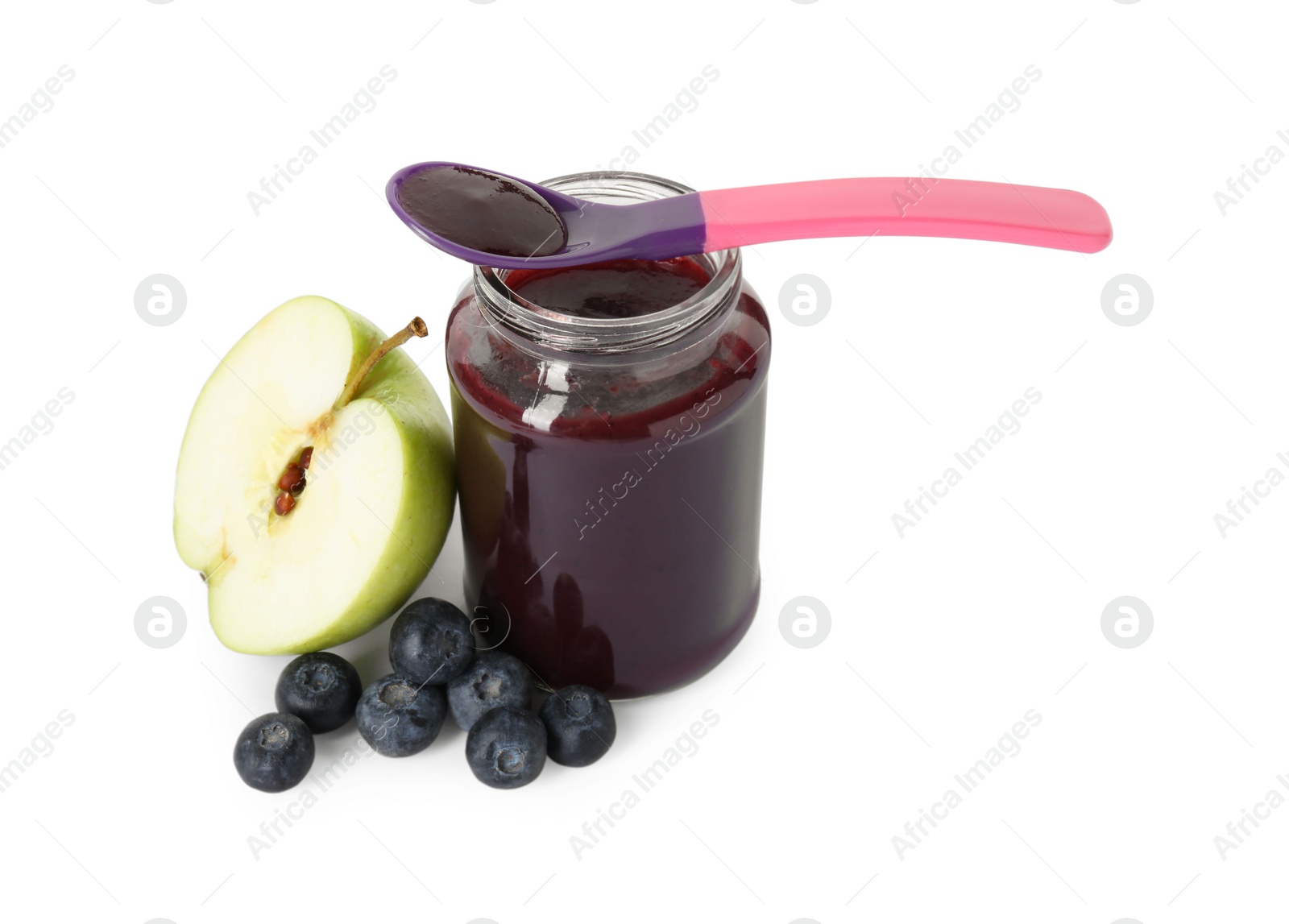 Photo of Jar with healthy baby food, spoon, fresh blueberries and half of apple isolated on white