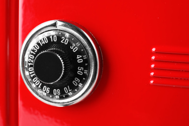 Photo of Red steel safe with mechanical combination lock, closeup