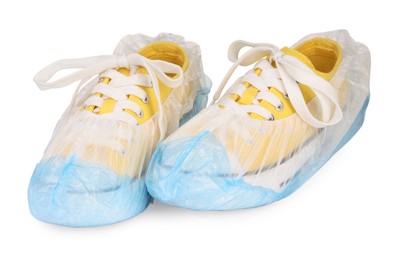 Sneakers in blue shoe covers isolated on white