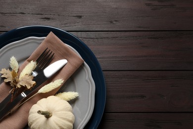 Autumn table setting on wooden background, top view. Space for text