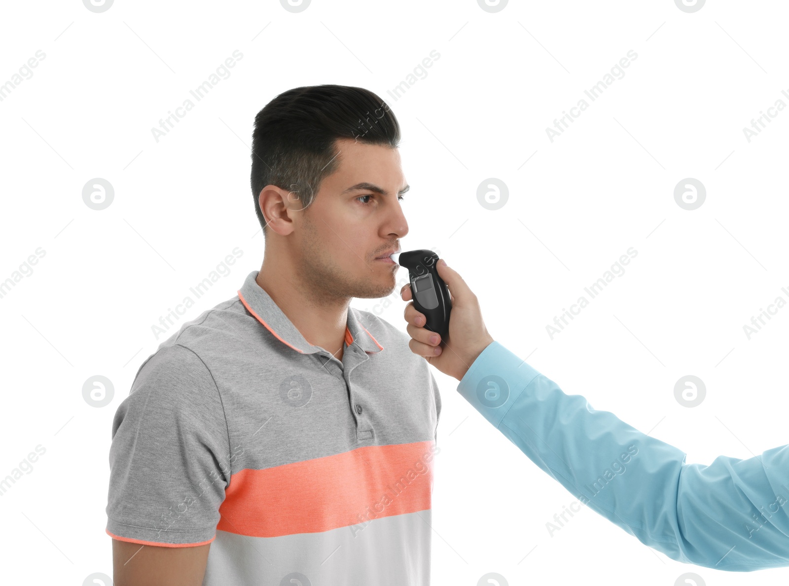 Photo of Inspector conducting alcohol breathe testing, man blowing into breathalyzer on white background