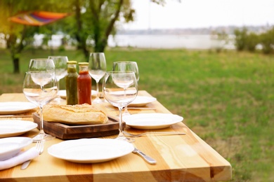 Set of dishware on table outdoors. Summer picnic