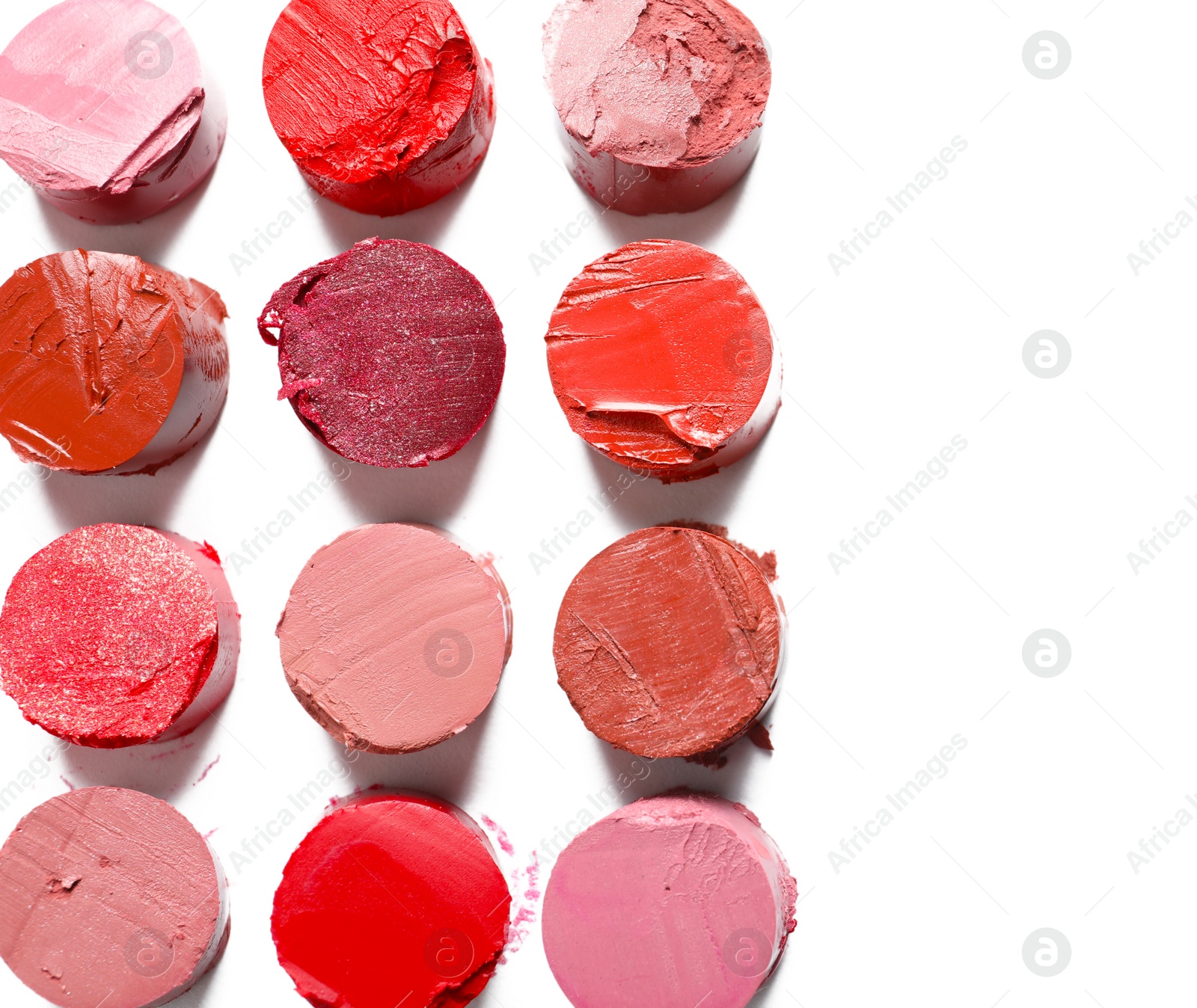 Photo of Different lipstick swatches on white background, top view