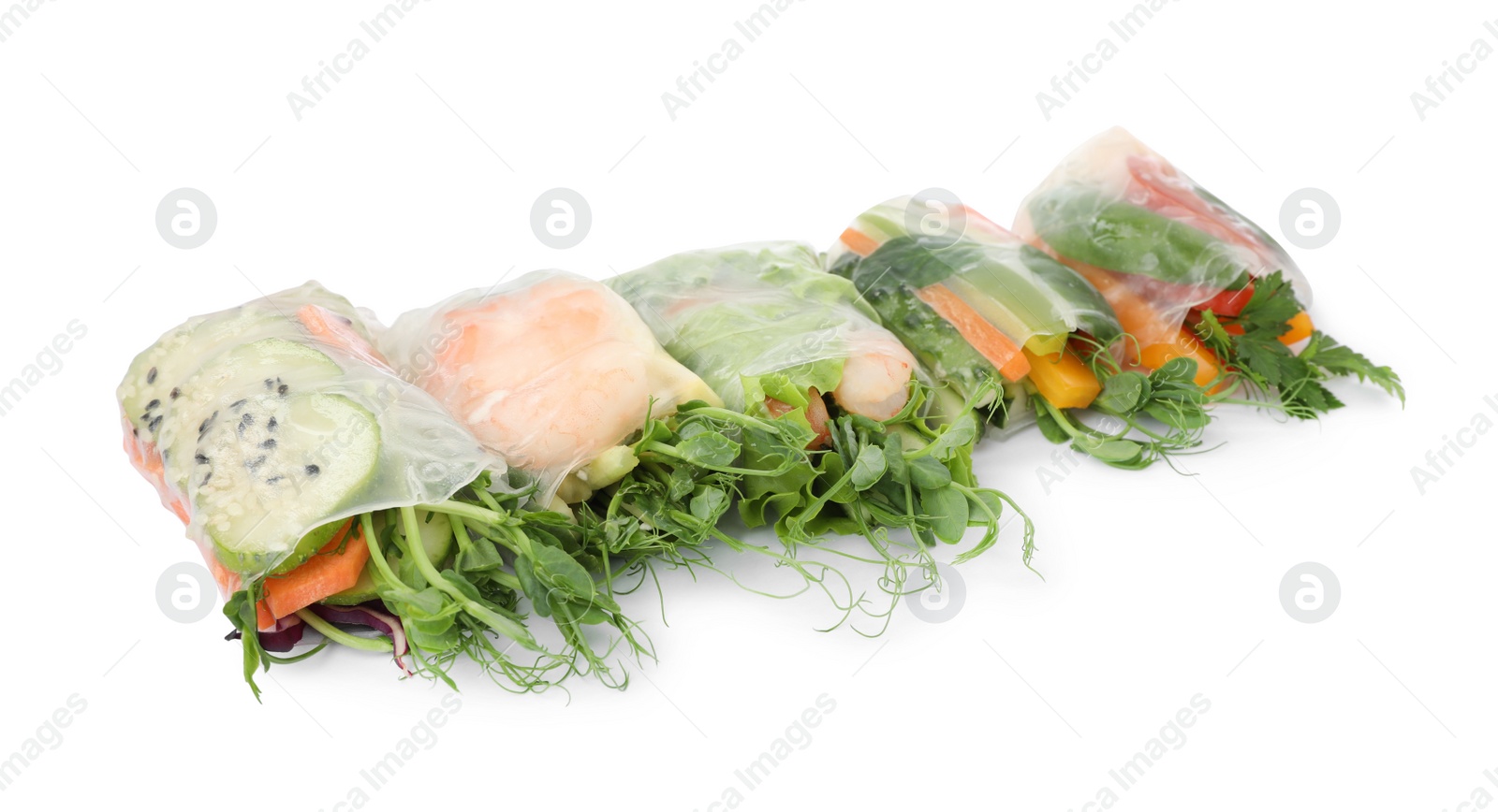 Photo of Many different delicious rolls wrapped in rice paper isolated on white