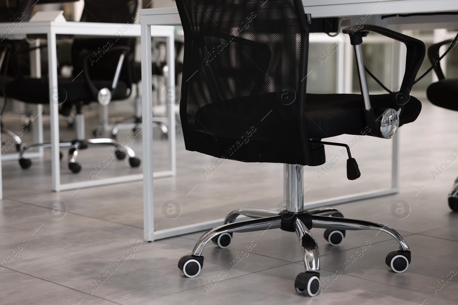 Photo of Comfortable office chairs and tables in meeting room, closeup